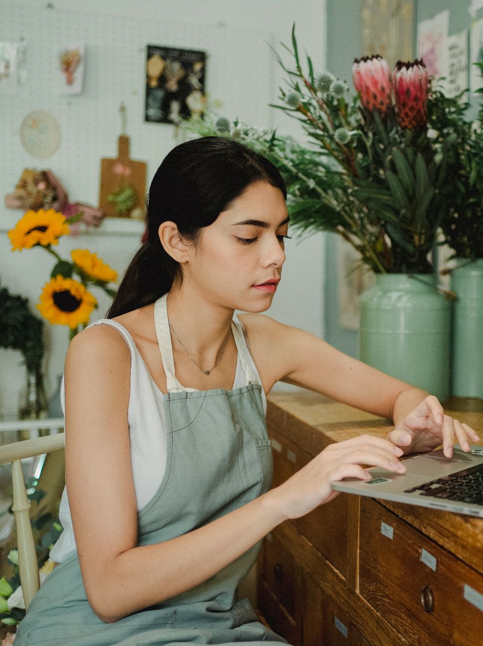 Small business owner reviewing digital marketing strategy on laptop