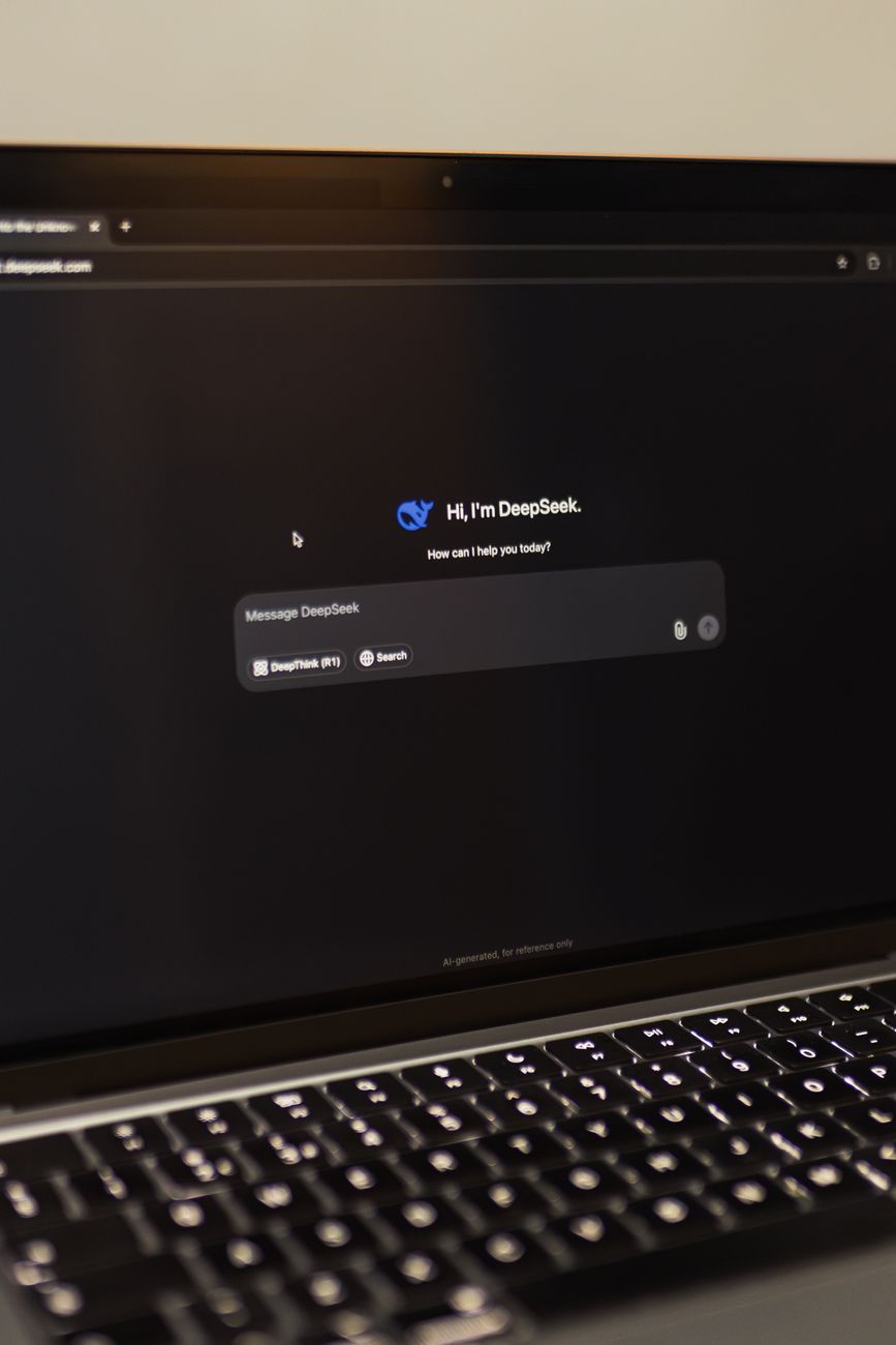 Marketer reviewing AI search results on a laptop in a modern office