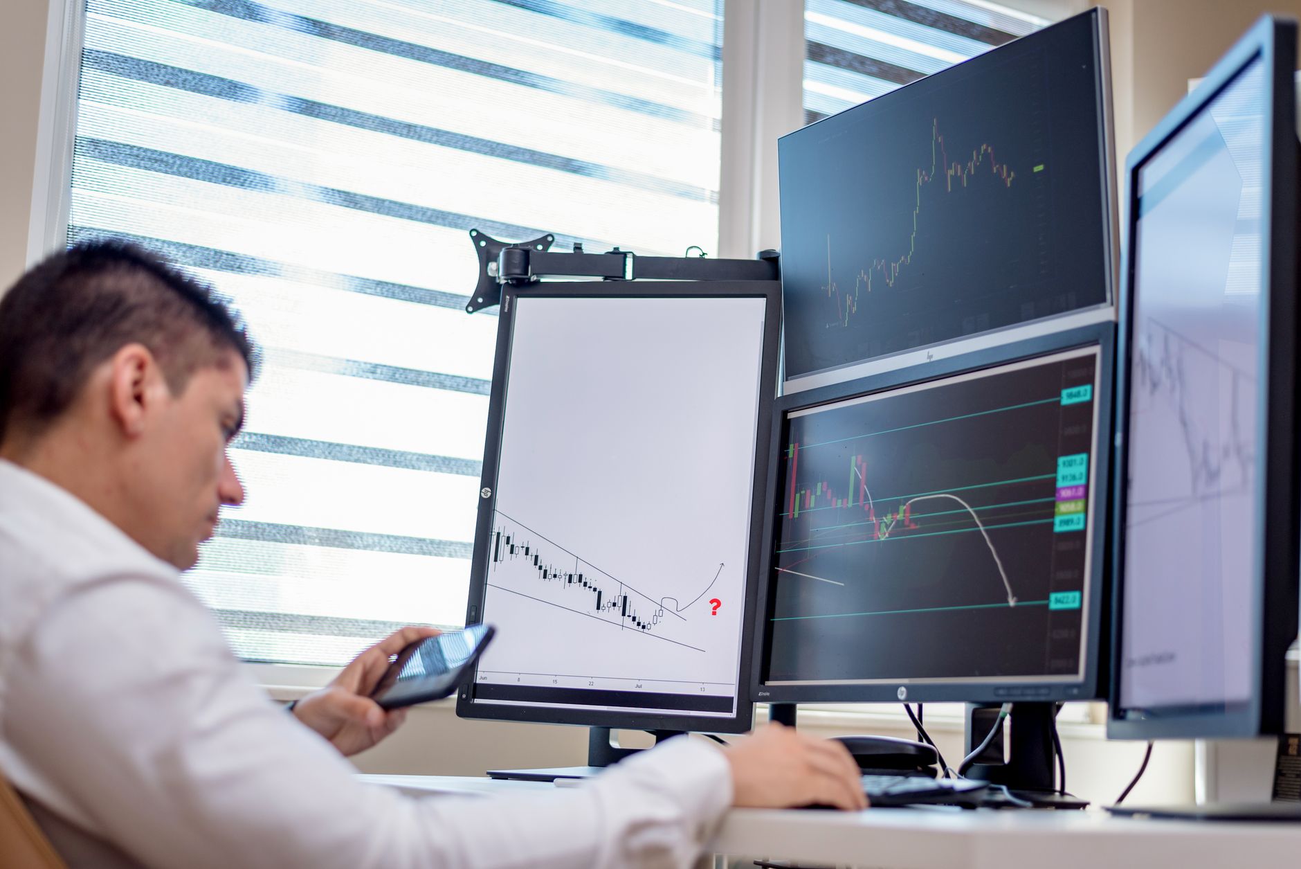 Digital marketer analyzing data charts and graphs on a monitor