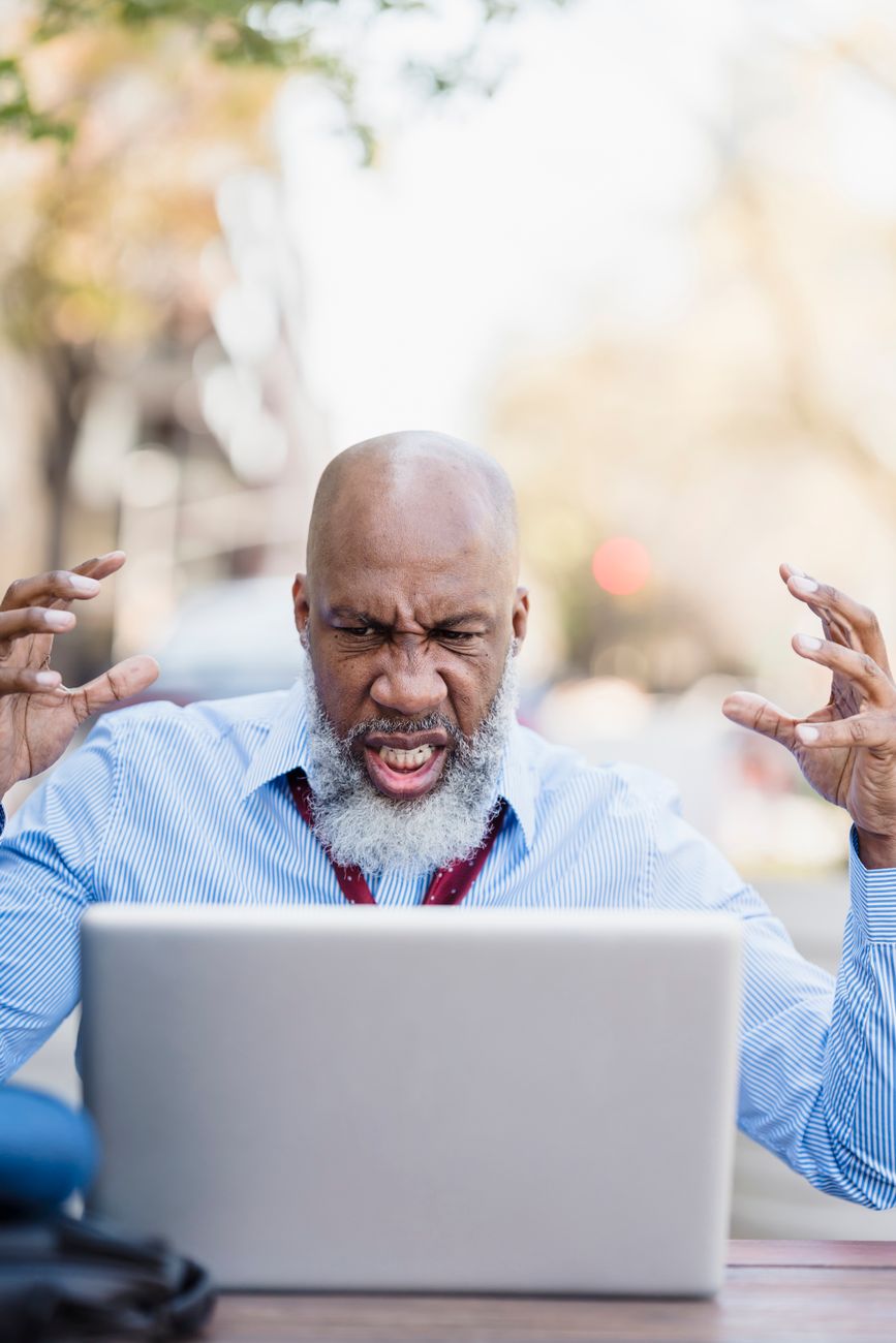 Frustrated business owner searching for a digital marketing agency on a laptop