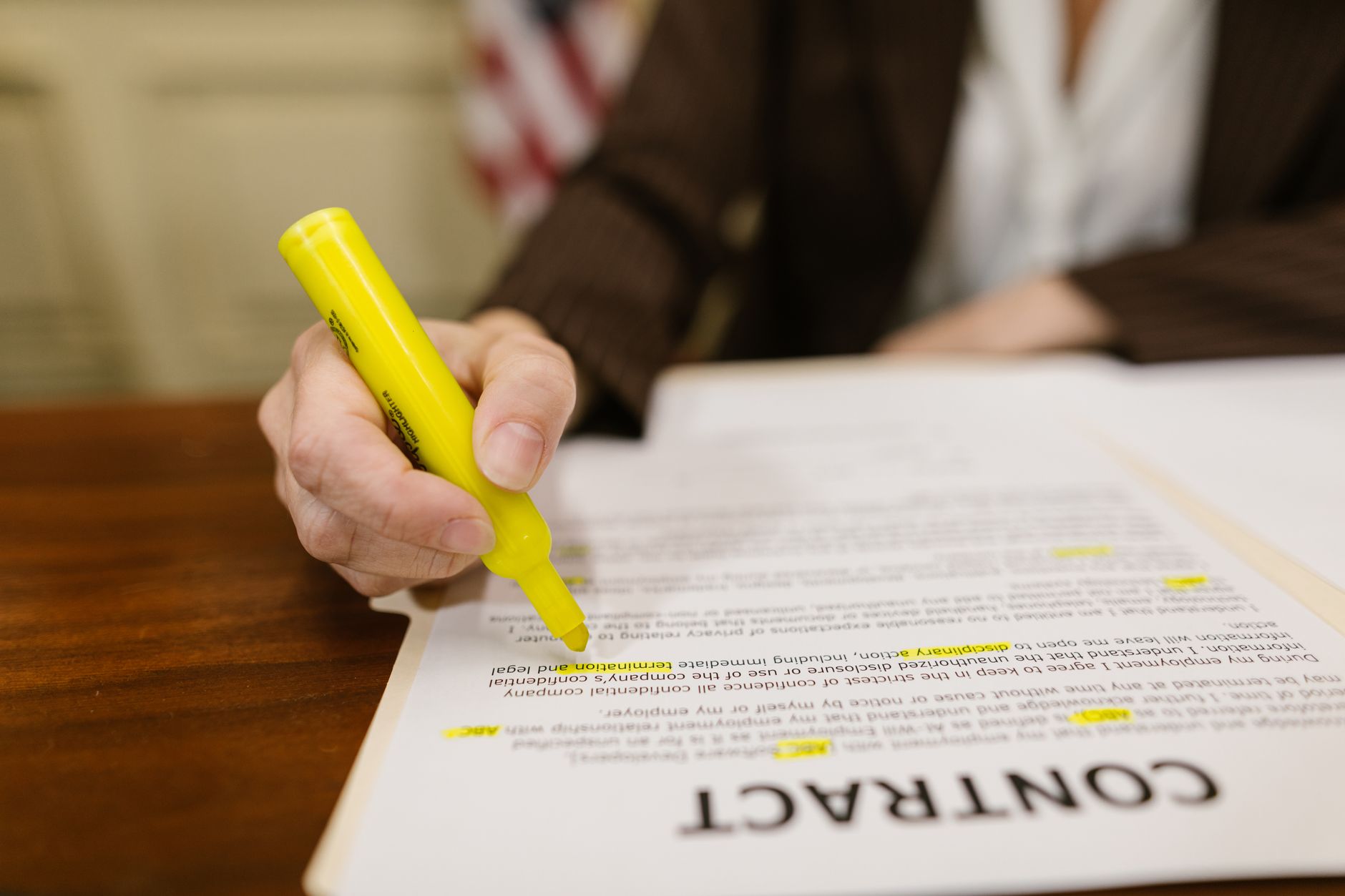Business owner reviewing a contract with a magnifying glass for red flags