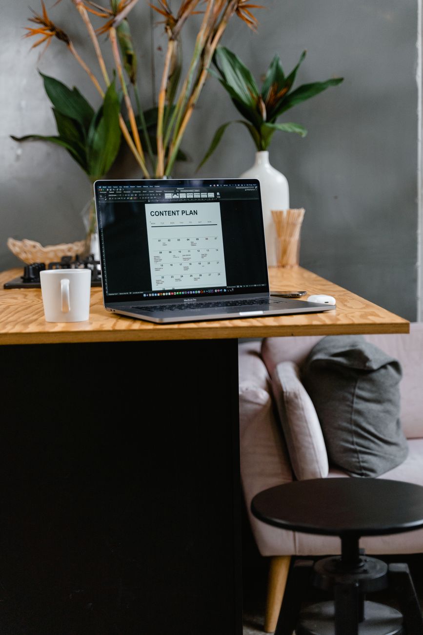 Person using AI tool on laptop to plan social media content calendar