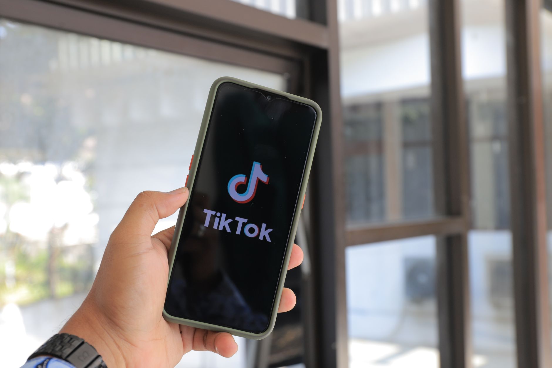 Person searching on TikTok app on smartphone