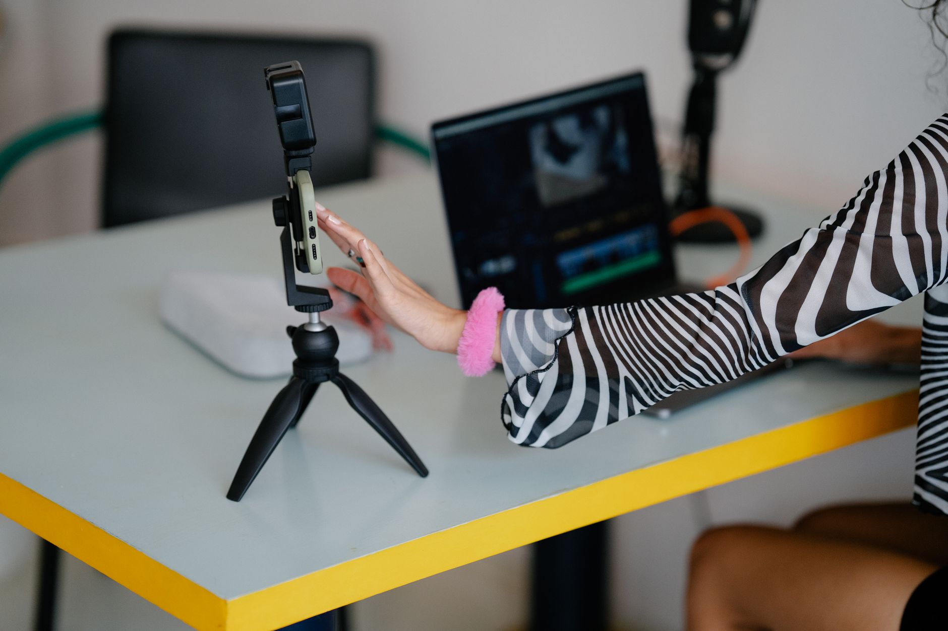 Focused content creator filming short video at desk
