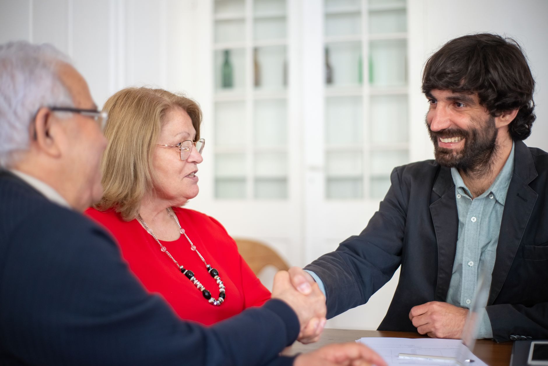 Business owner shaking hands with a digital marketing consultant in an office meeting