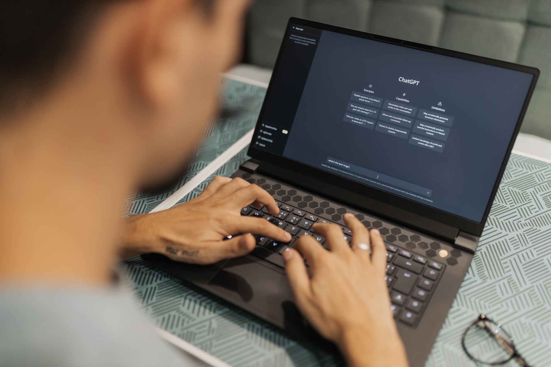 Person using ChatGPT on a laptop for SEO research