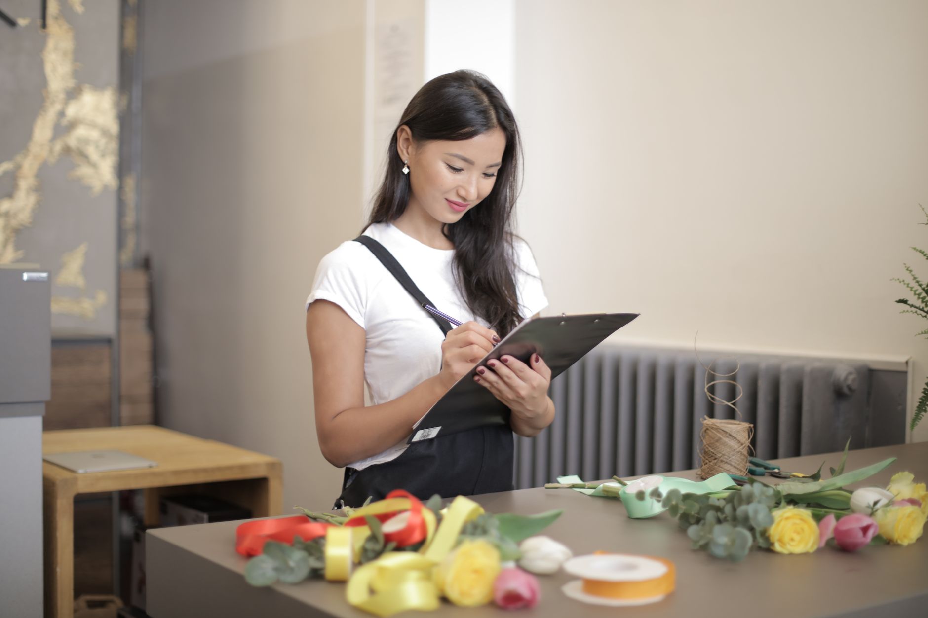 Small business owner reviewing SEO checklist on paper next to a computer
