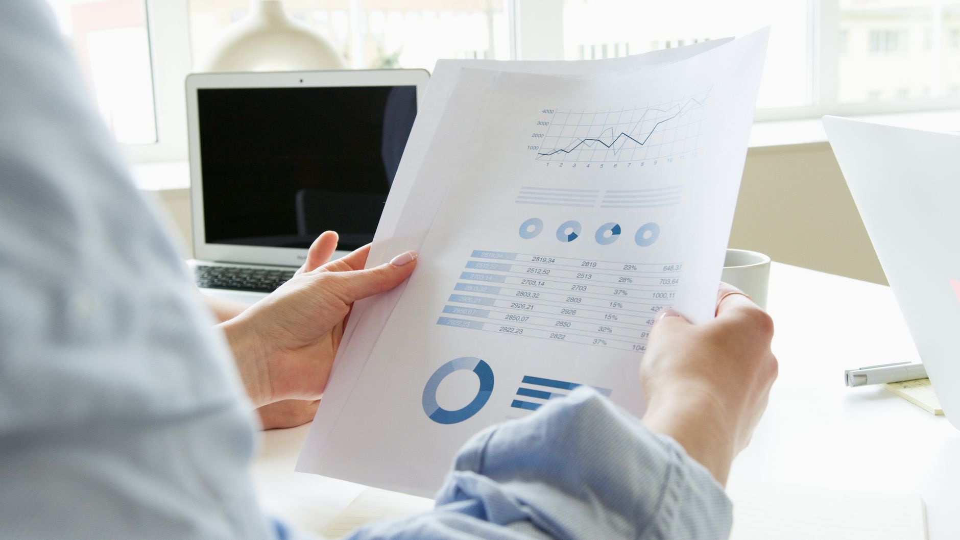 Person reviewing SEO audit report on laptop with prioritized action items