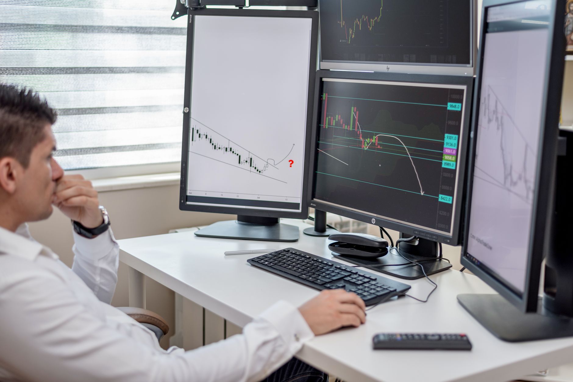 SEO specialist analyzing website audit report data on multiple screens