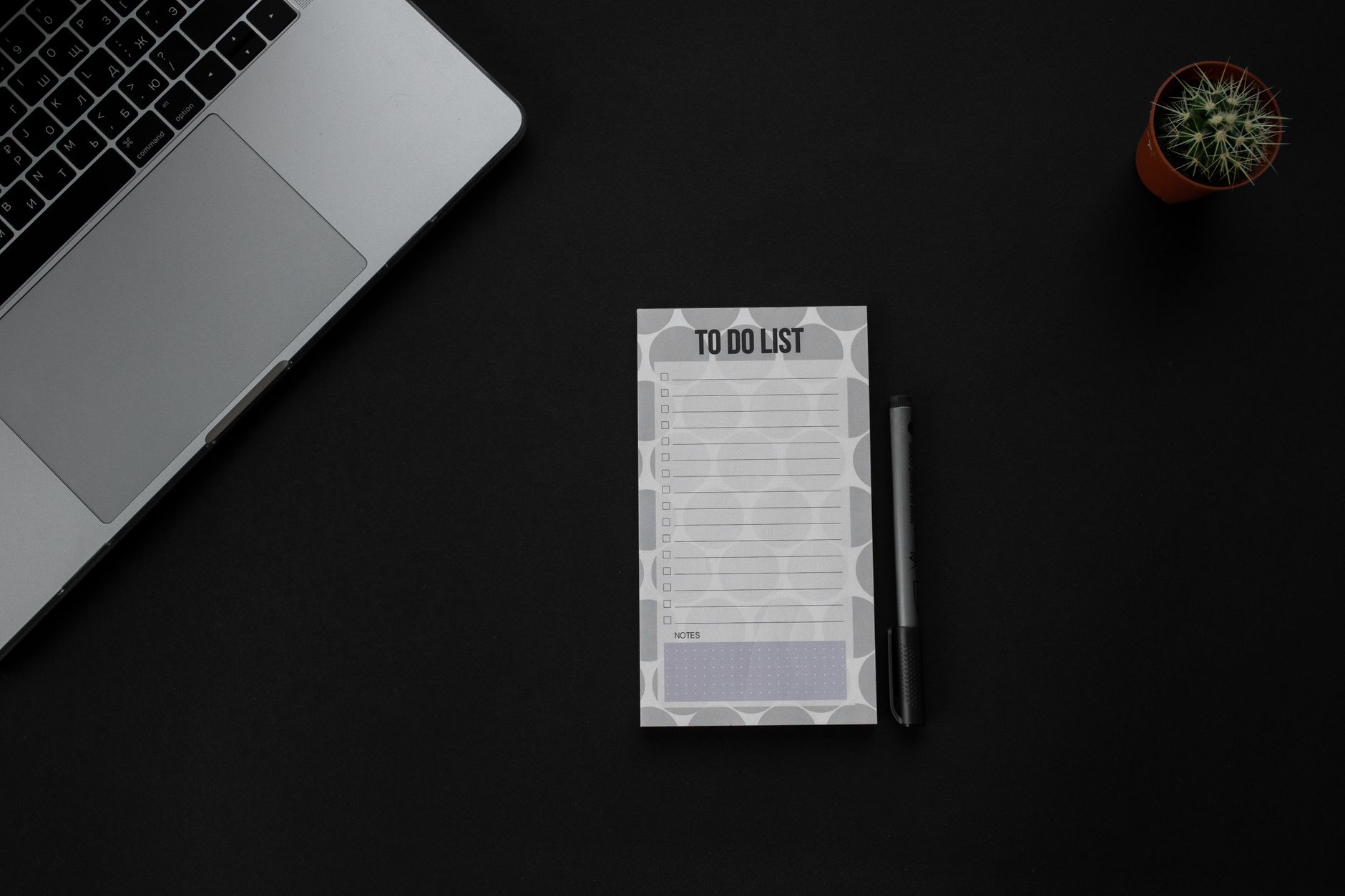 Prioritized SEO fix checklist on a notepad beside a laptop