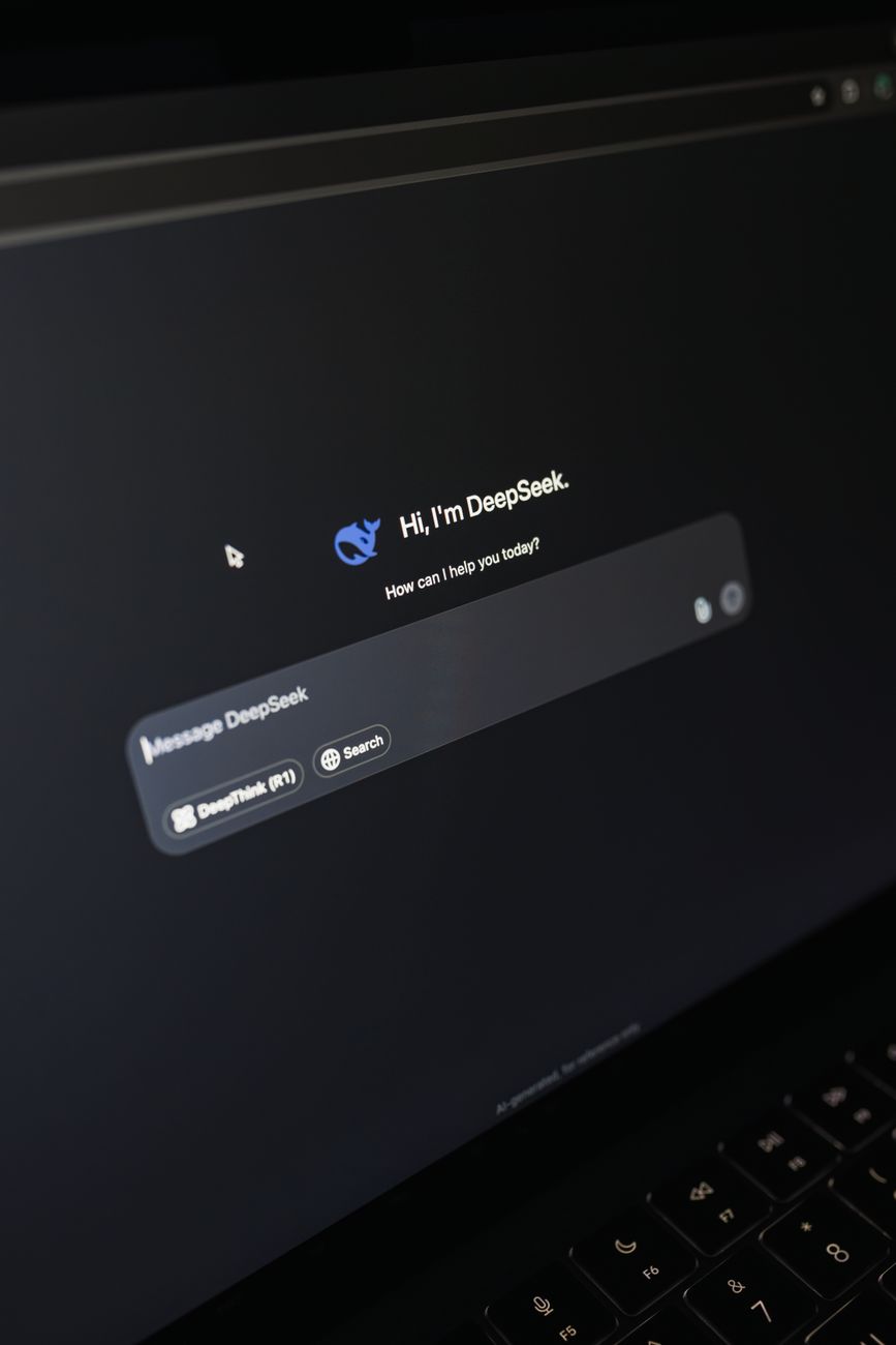 Person using ChatGPT on a laptop alongside an SEO dashboard