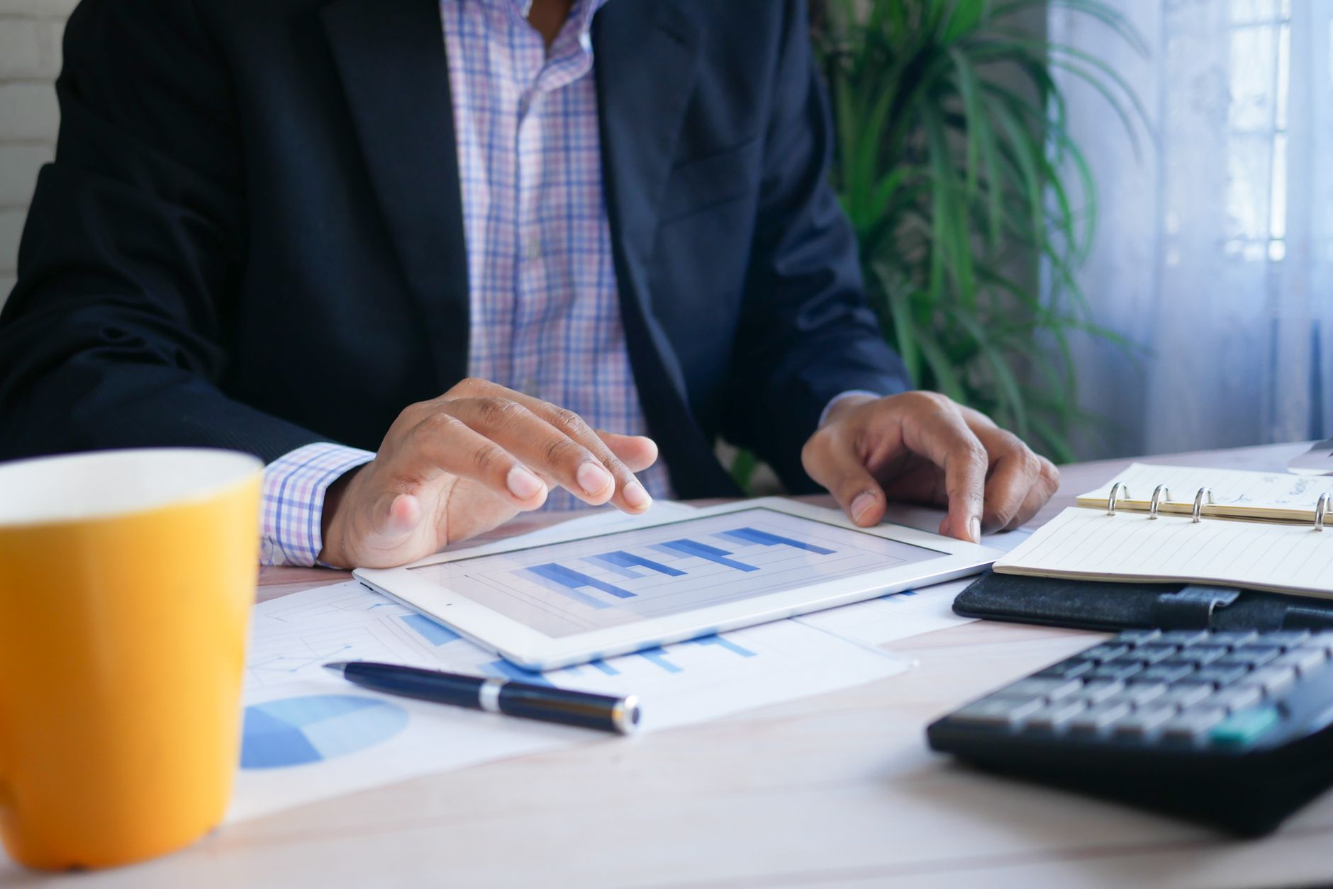Person analyzing SEO score report with charts and graphs on tablet