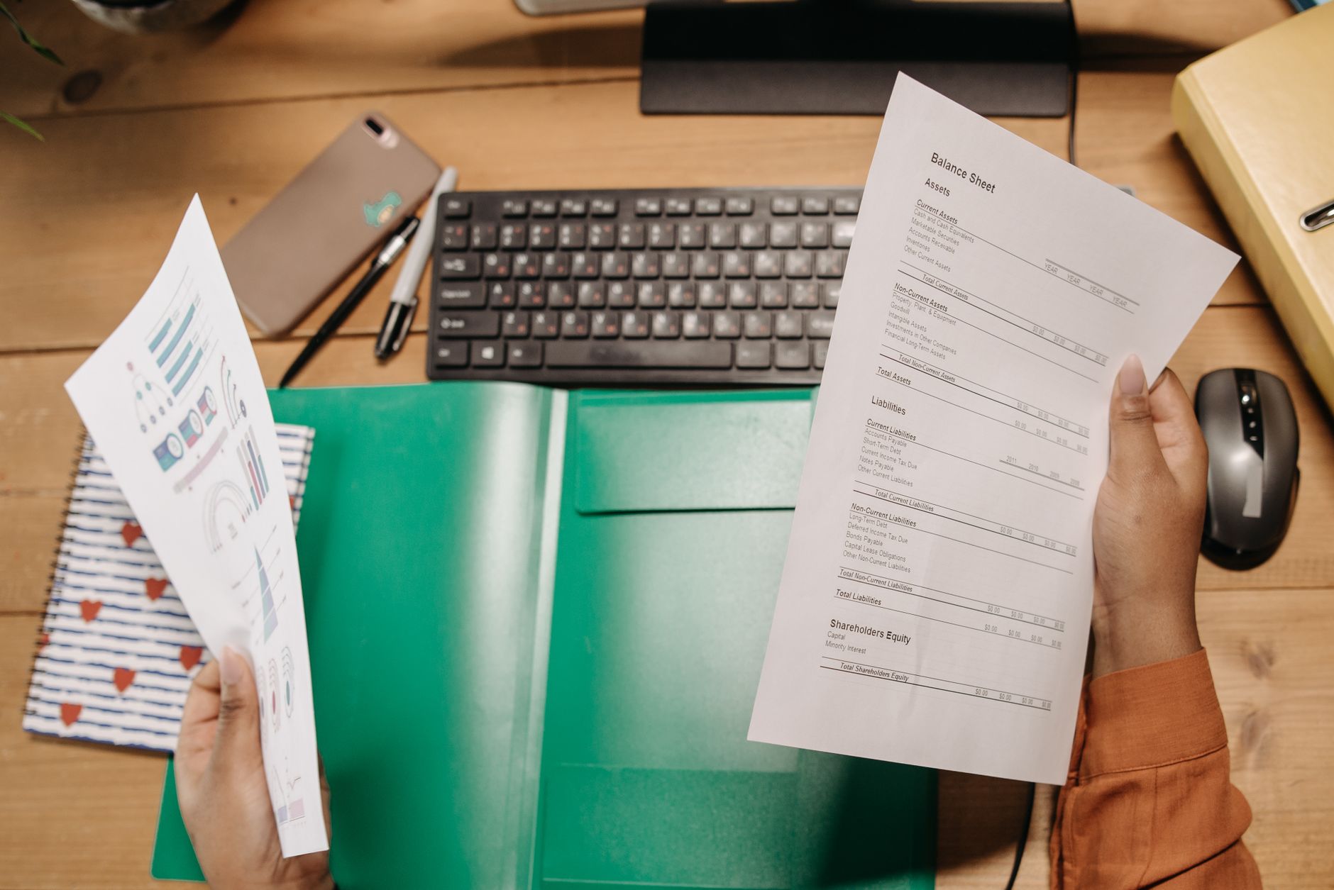 Professional SEO audit report PDF document on a desk beside a laptop