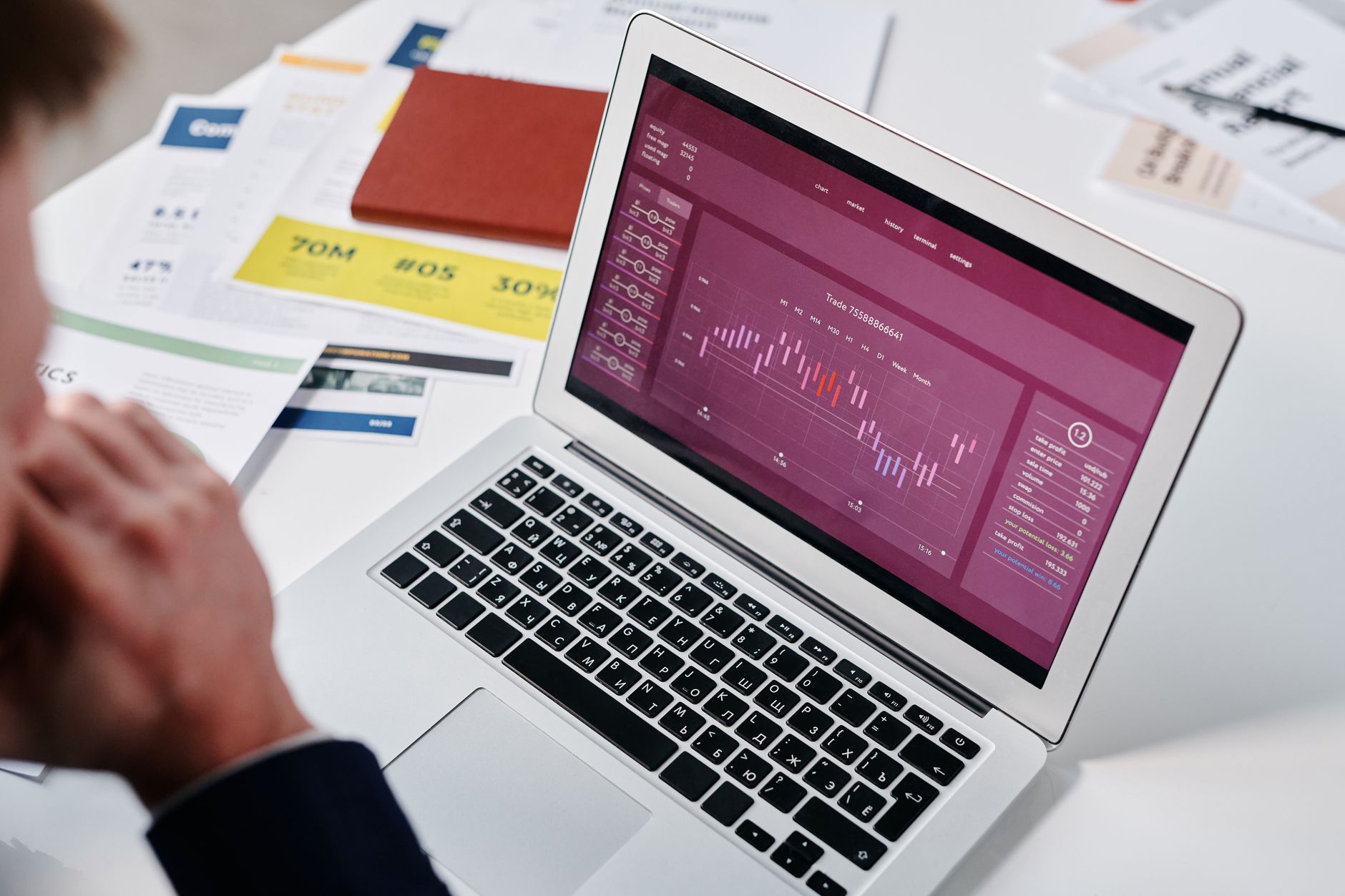 Person reviewing an SEO audit report PDF on a laptop at a desk
