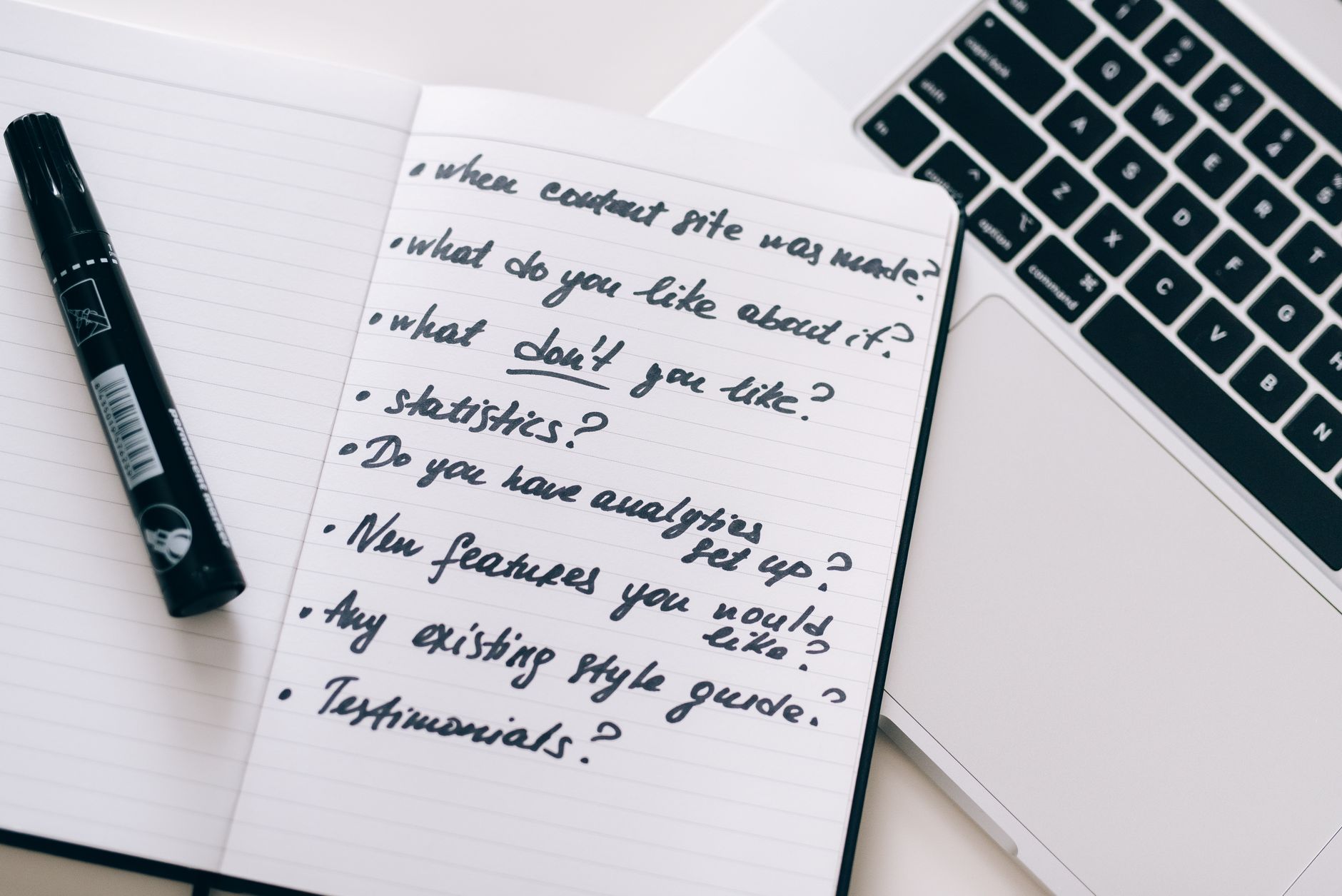 Content strategist reviewing website pages on a laptop for SEO improvements
