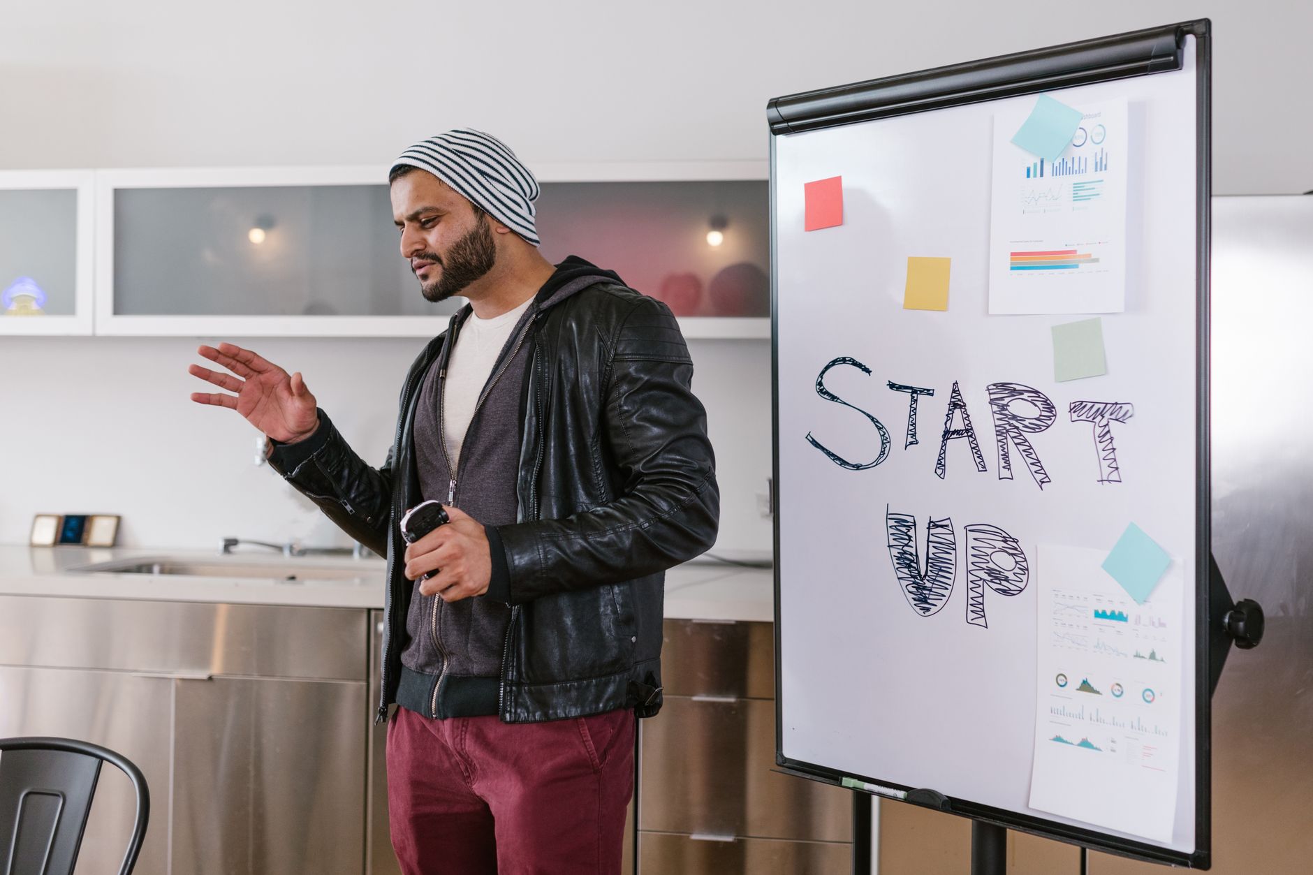 African entrepreneur presenting digital business model on whiteboard