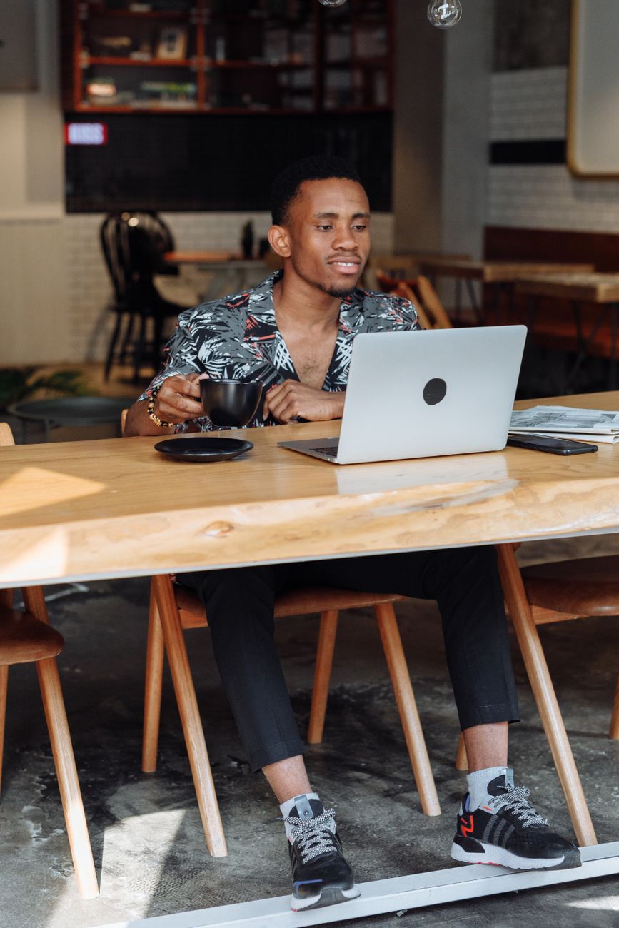 African entrepreneur working on a laptop in a modern co-working space