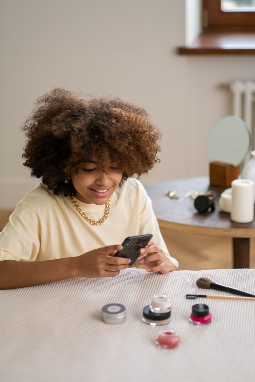 African creator optimizing social media profile on smartphone