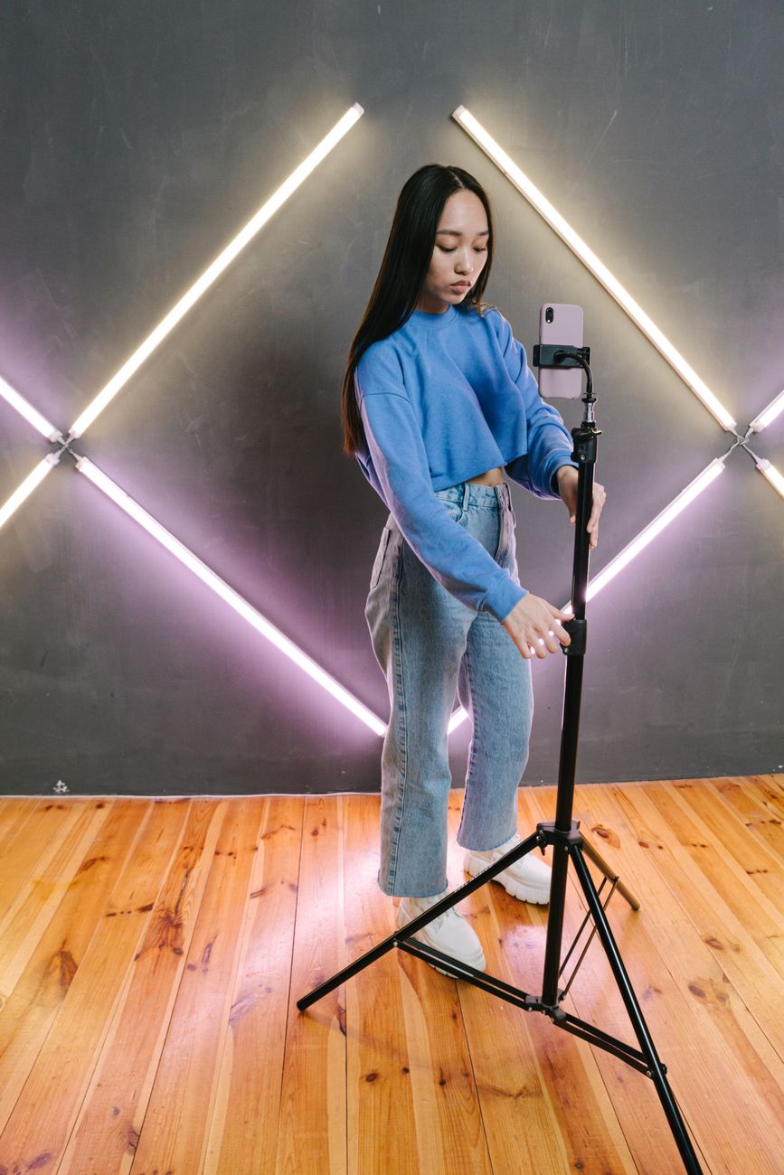 African content creator filming a video on smartphone in a bright studio
