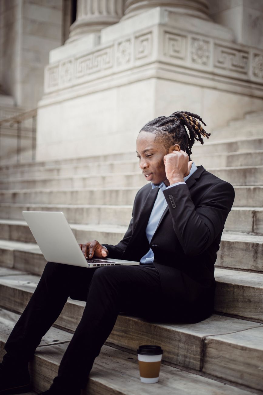 African entrepreneur reviewing social media analytics on laptop