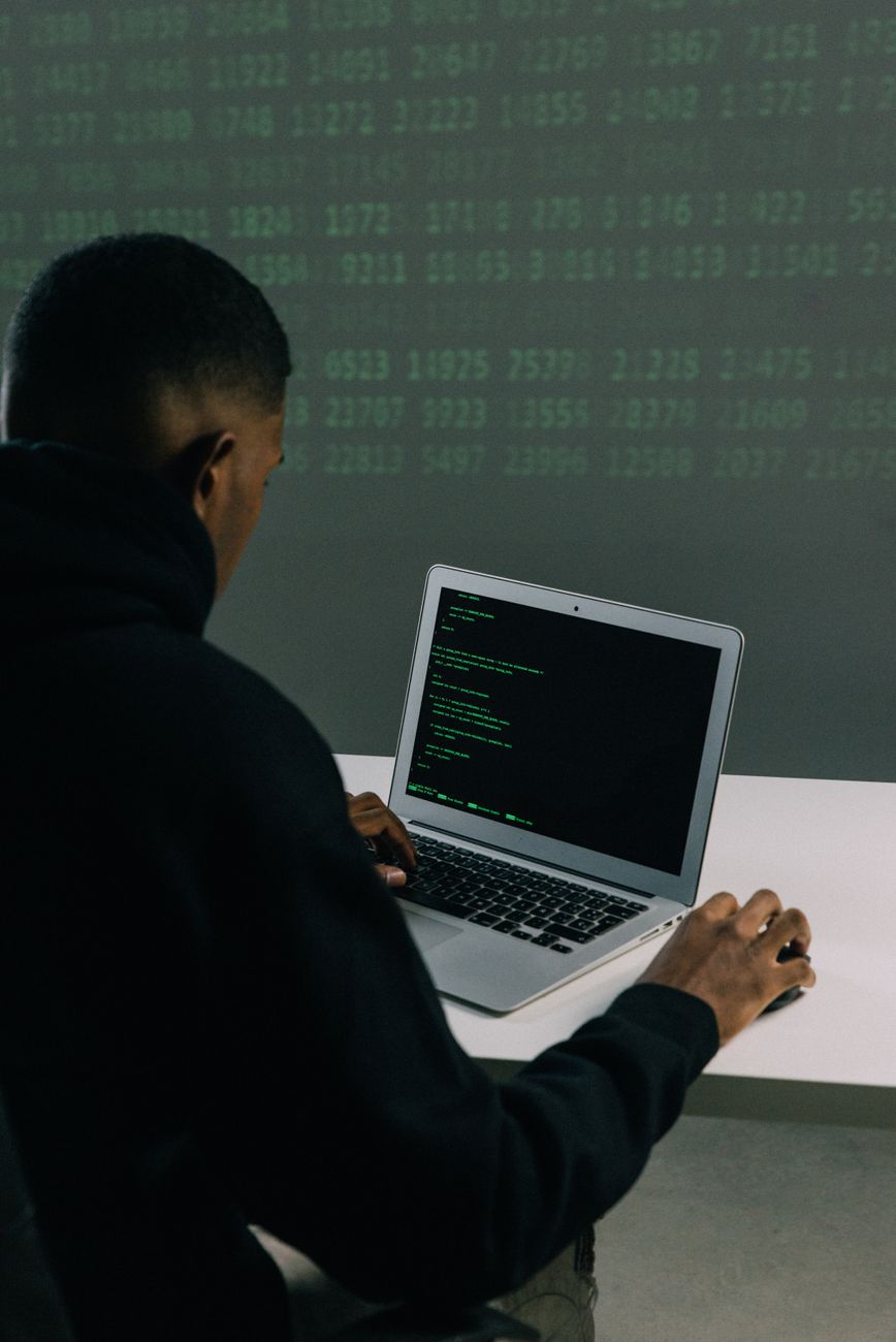African developer using AI storytelling software on laptop