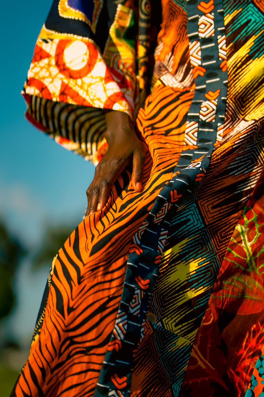 African fashion designer showcasing wearable tech textile at expo