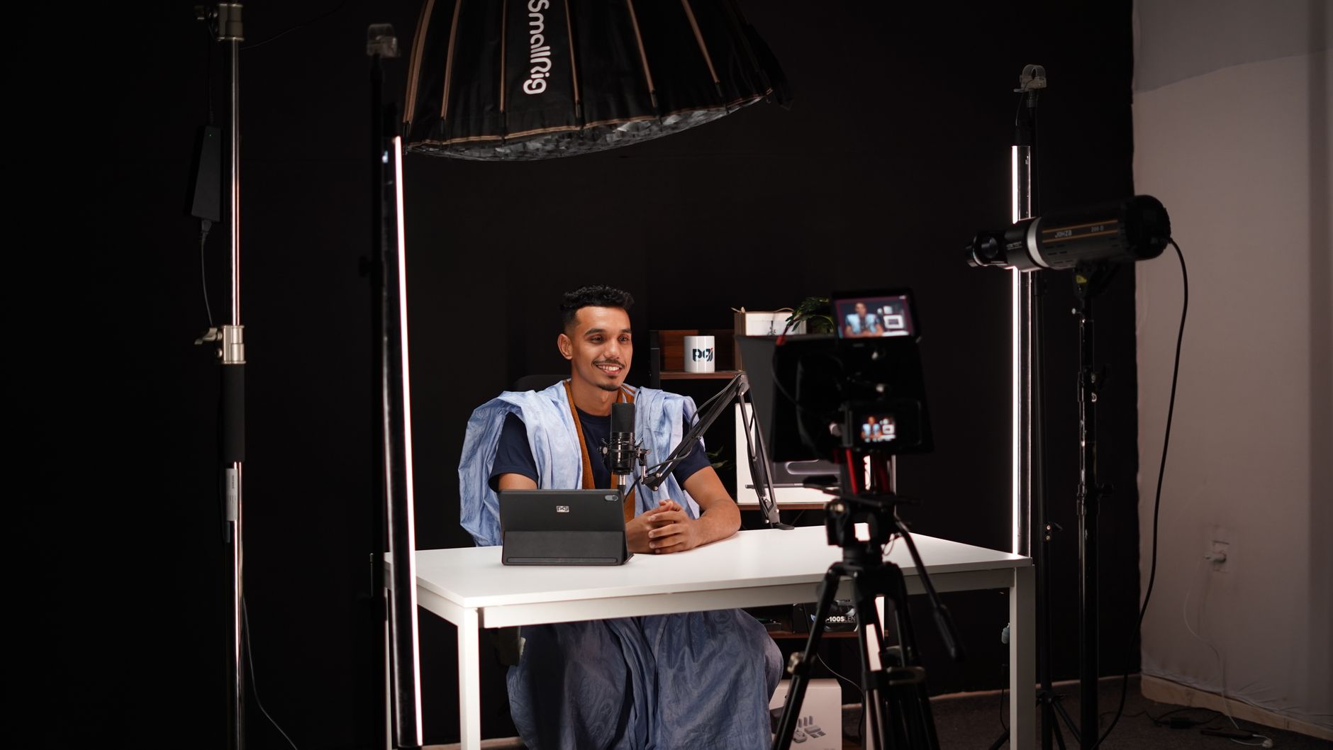 African content creator filming a video in a professional studio setup