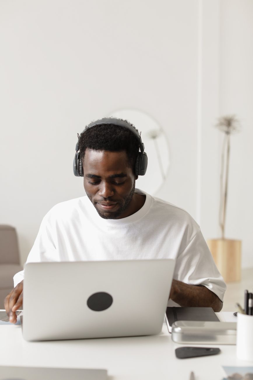 African digital creator working on laptop with creative content on screen