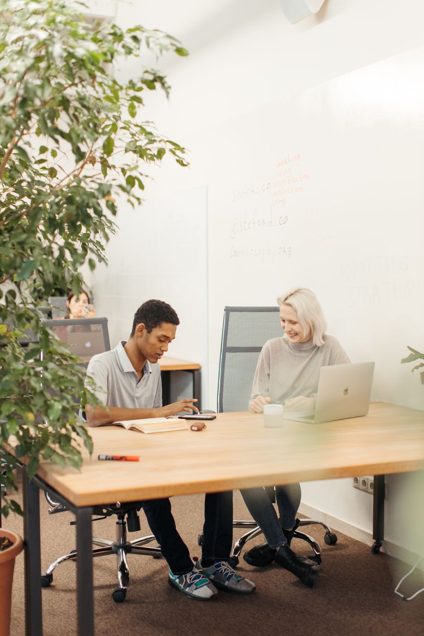 African tech hub interior with creators working on laptops and creative projects
