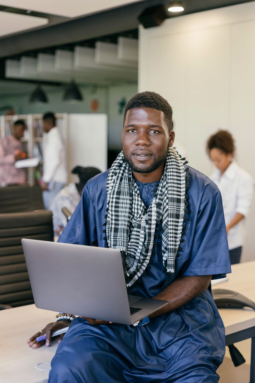 African tech entrepreneur working on a laptop in a modern innovation hub