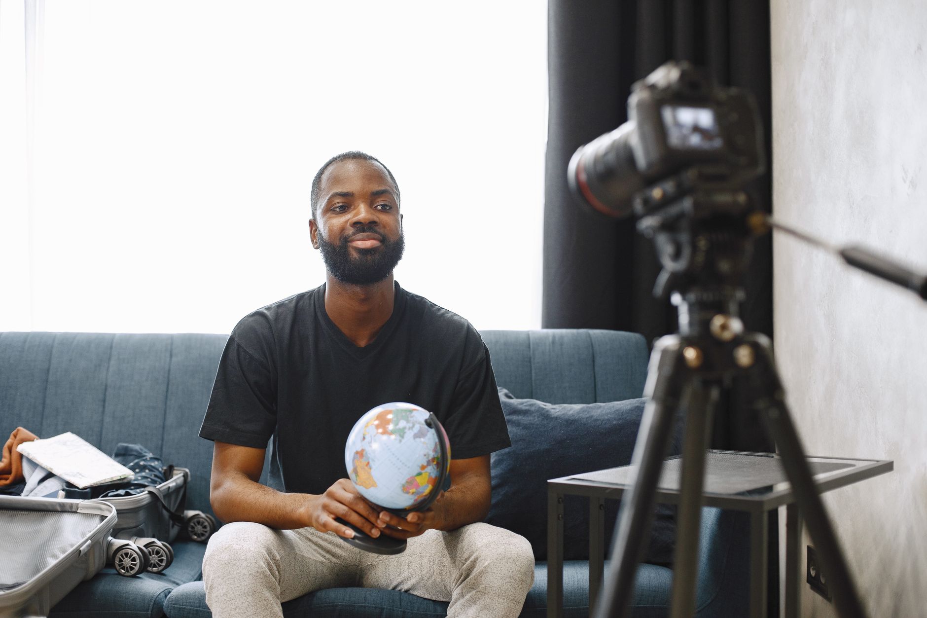 African content creator recording a YouTube video in a home studio