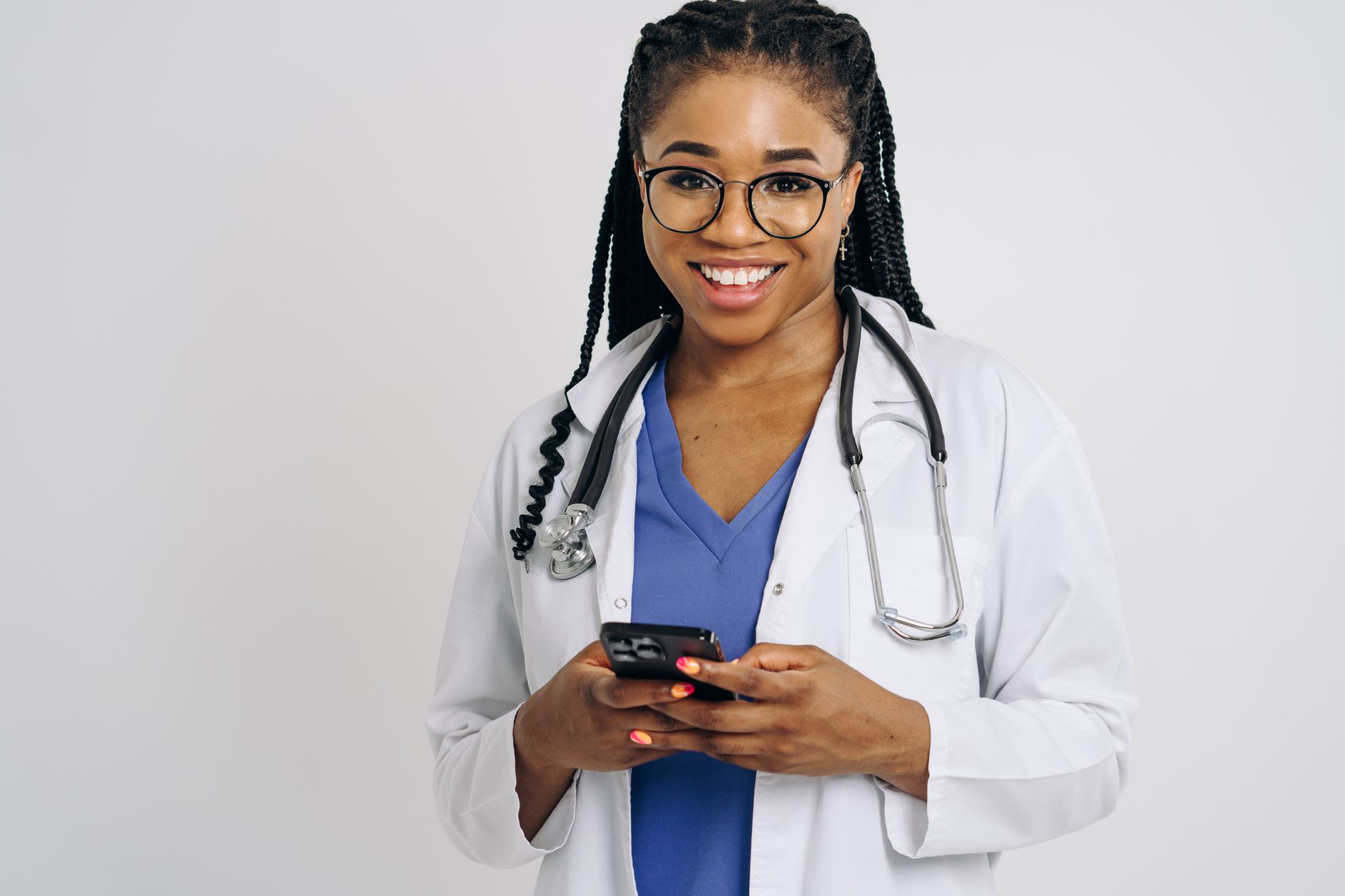 African healthcare worker using a smartphone to manage medical supply logistics