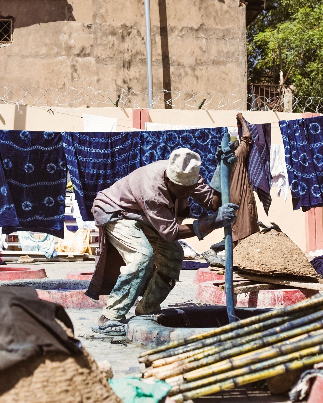 African artisan indigo dyeing fabric workshop