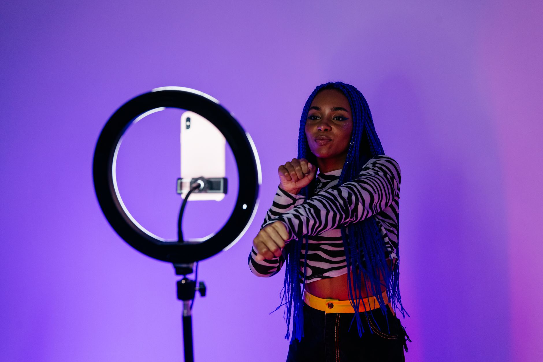 African YouTuber filming video content in studio setup