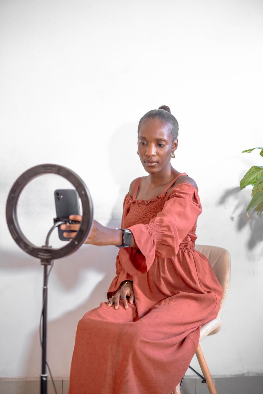 African fashion photographer showcasing portfolio on Instagram mobile app