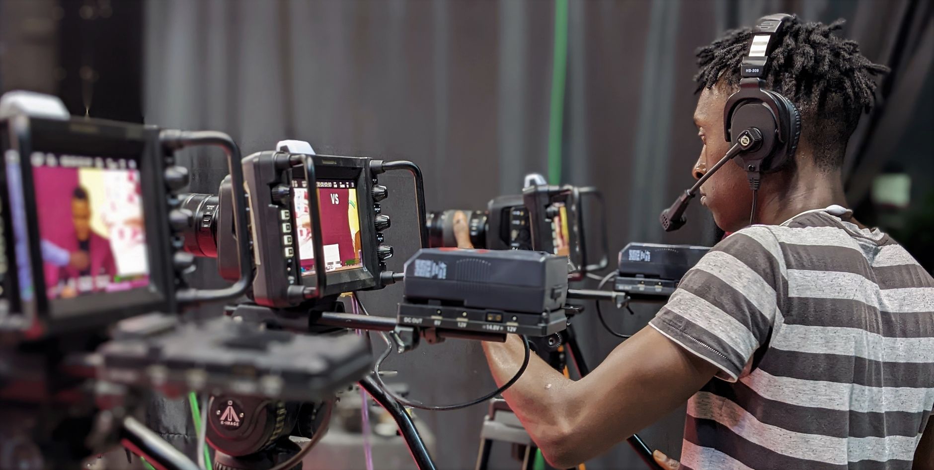African content creator filming video in a professional studio setup