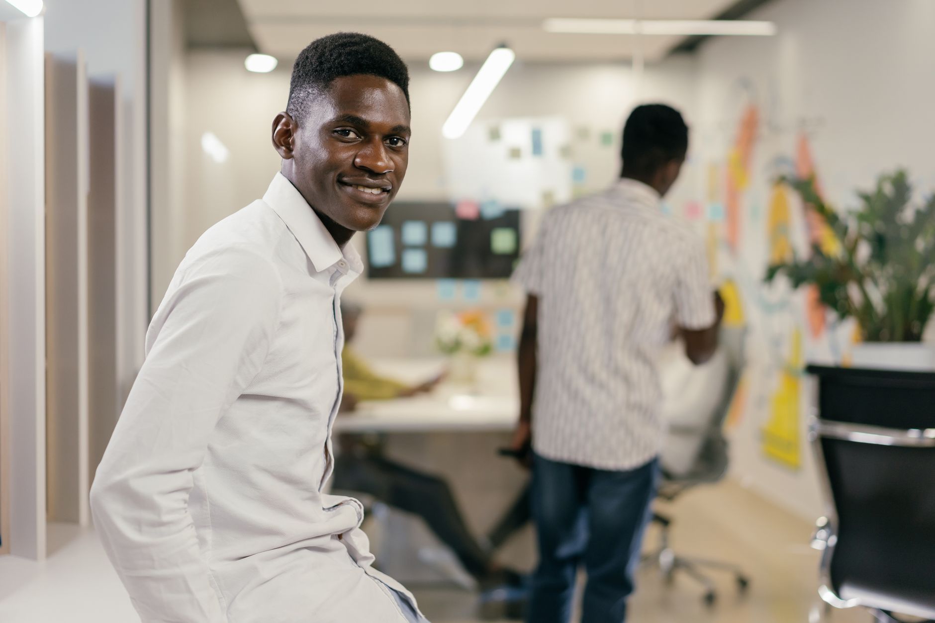 African tech innovators collaborating in a modern co-working space