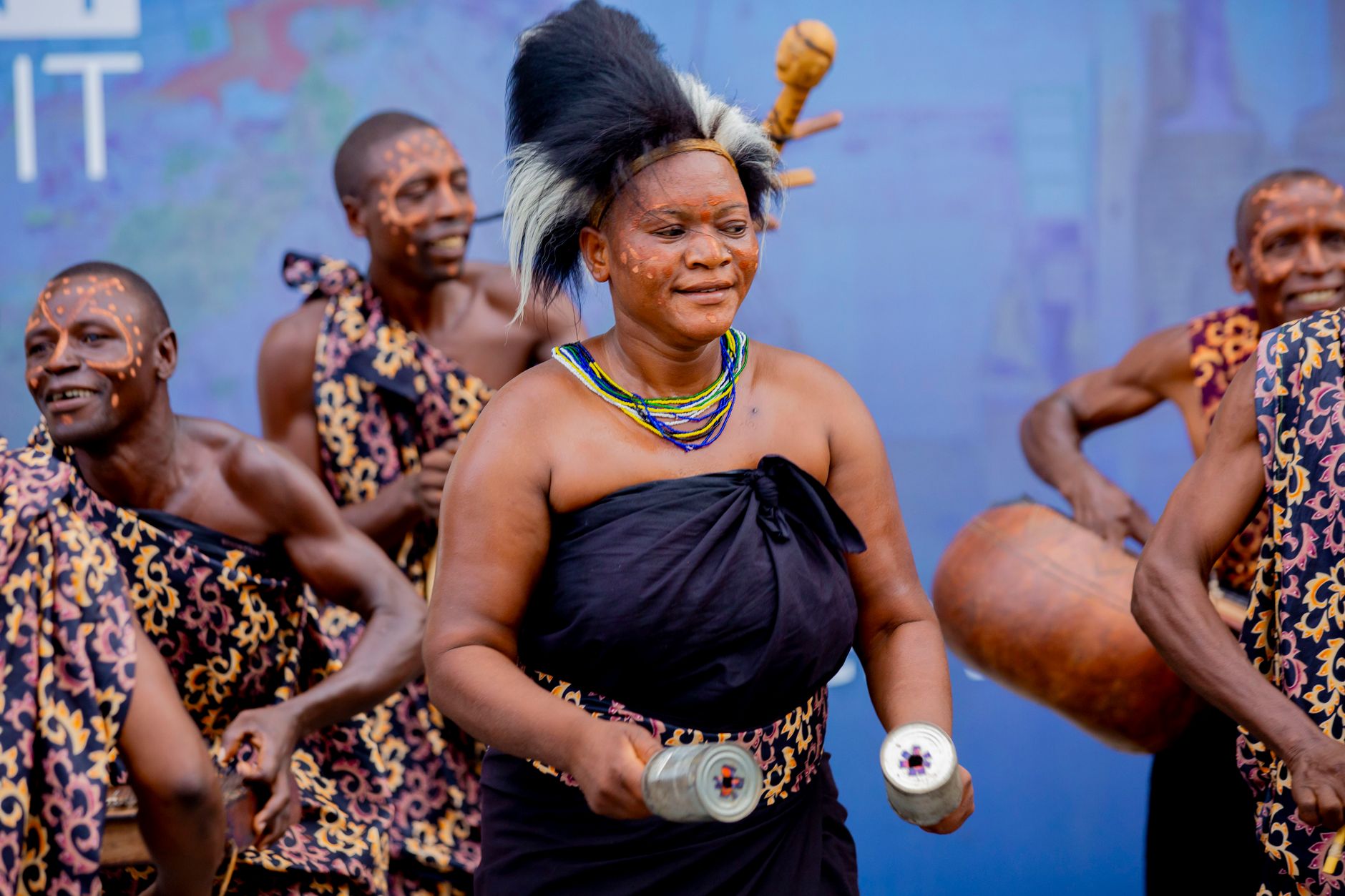 Diverse group of Africans in traditional attire celebrating together at a community gathering