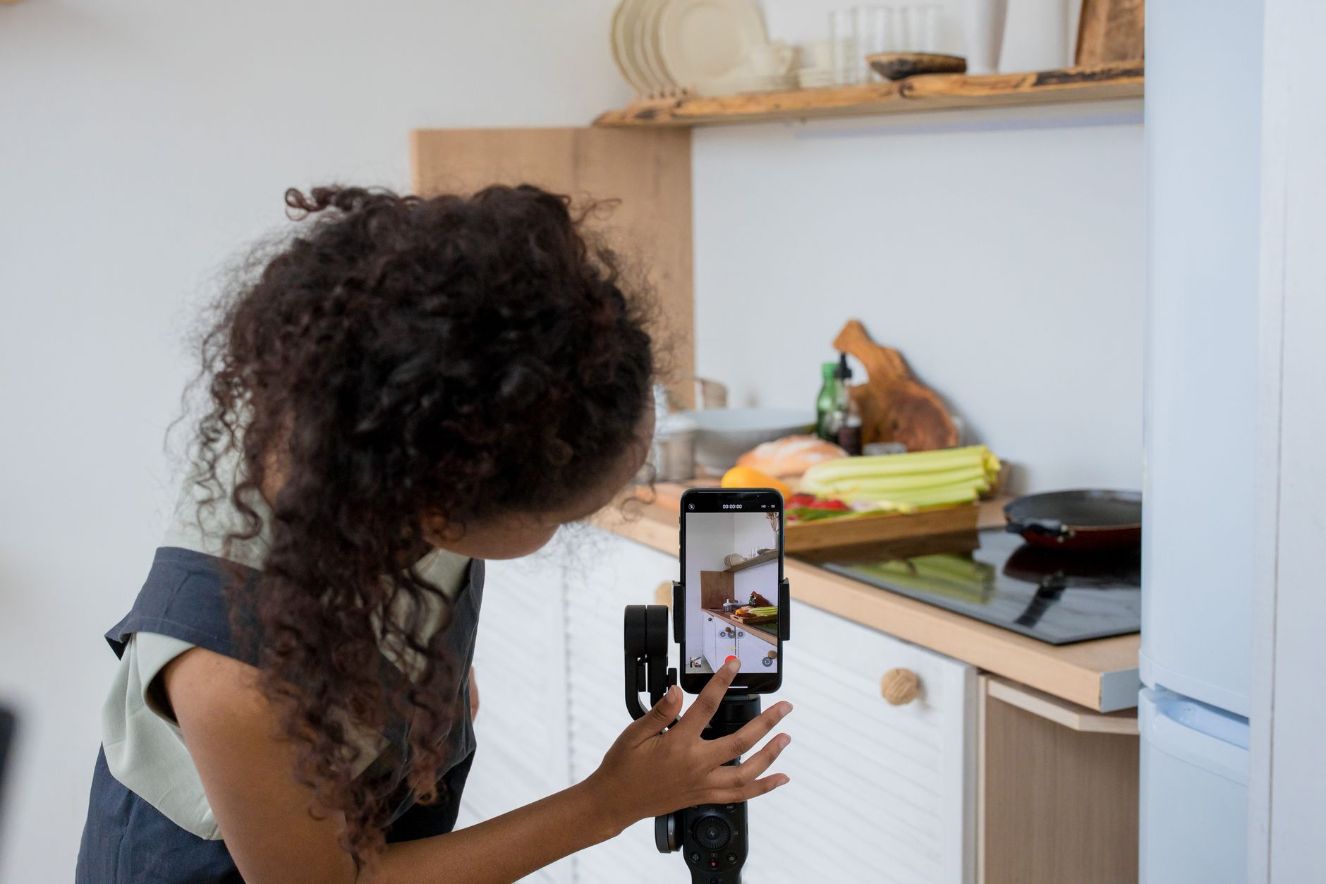 African creator recording video content on smartphone for social media platform