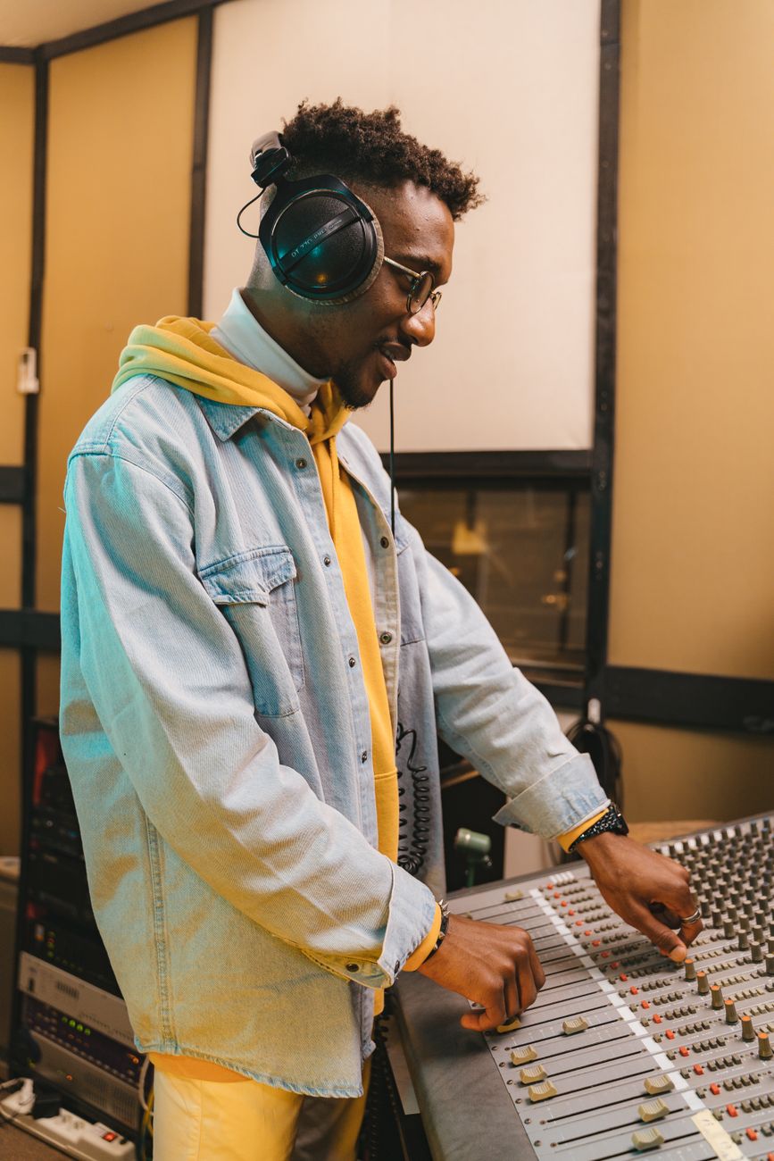 African music producer recording audio in a professional studio