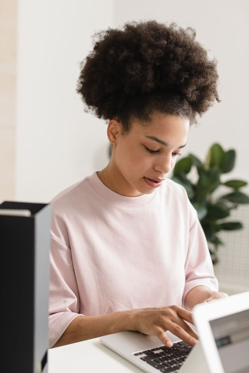 African creator at a desk reviewing analytics and content strategy on a laptop