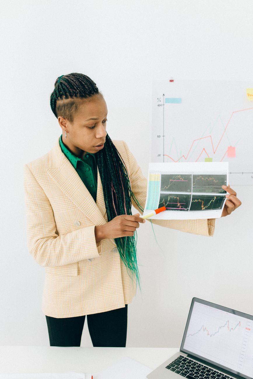 African marketer analyzing creator data on a laptop in a modern office