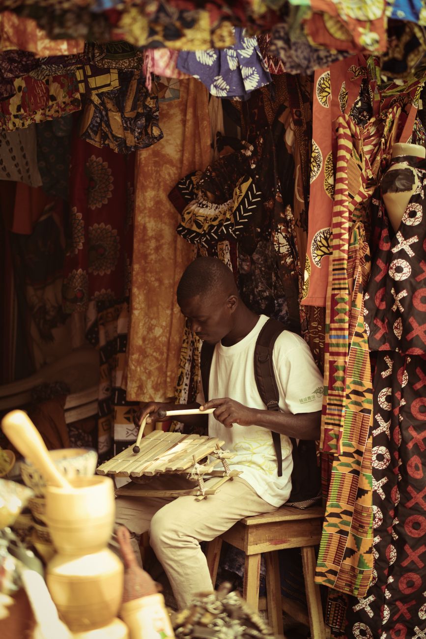 Vibrant African textile market with kente cloth and woven fabrics on display