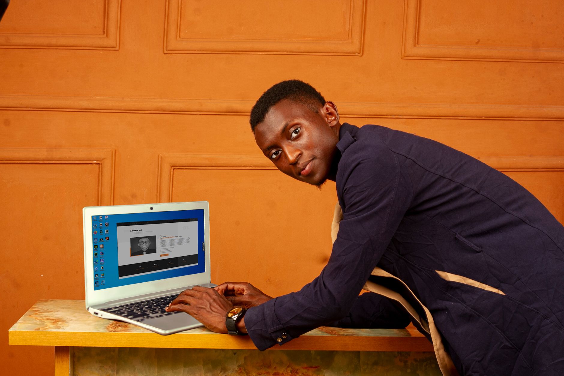 African entrepreneur using laptop powered by solar energy