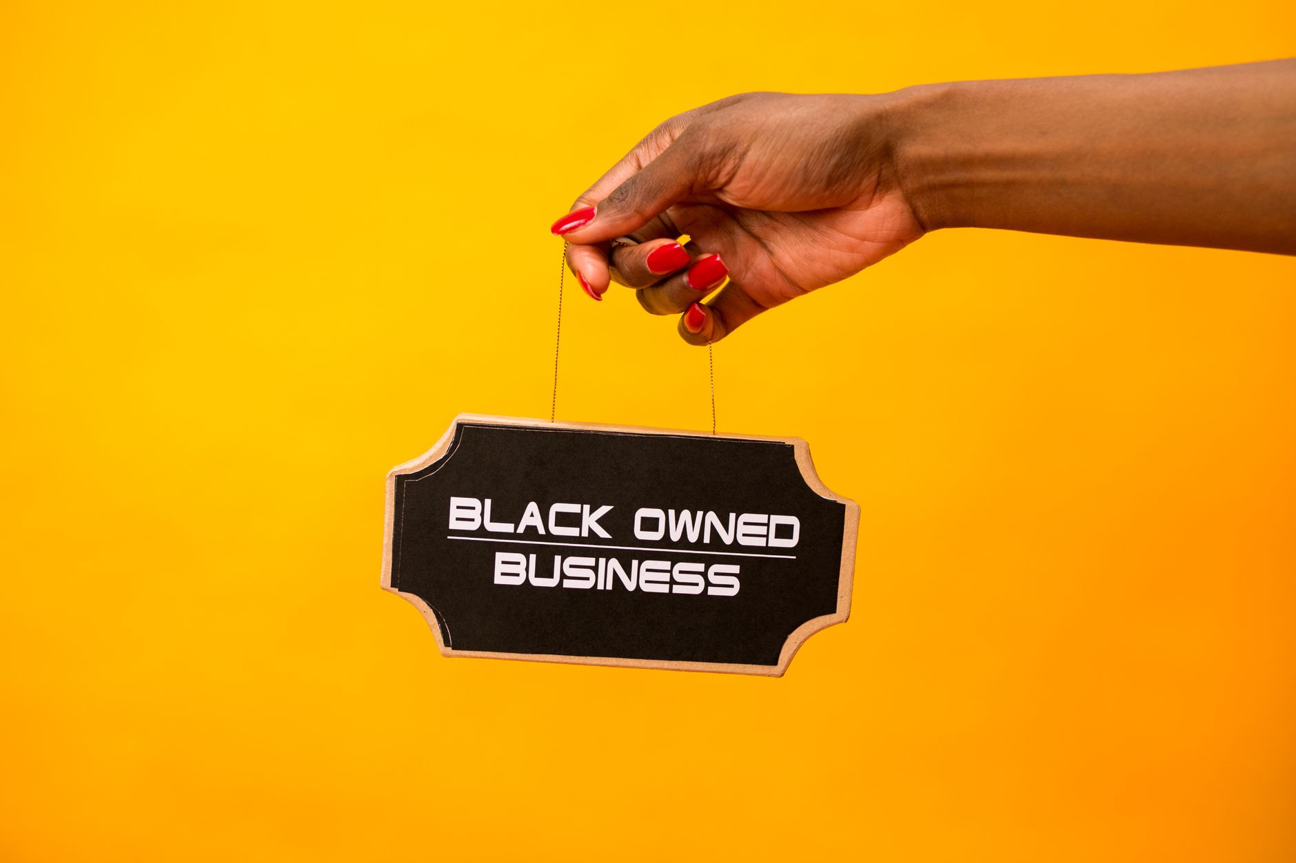 African entrepreneur working on laptop with brand products