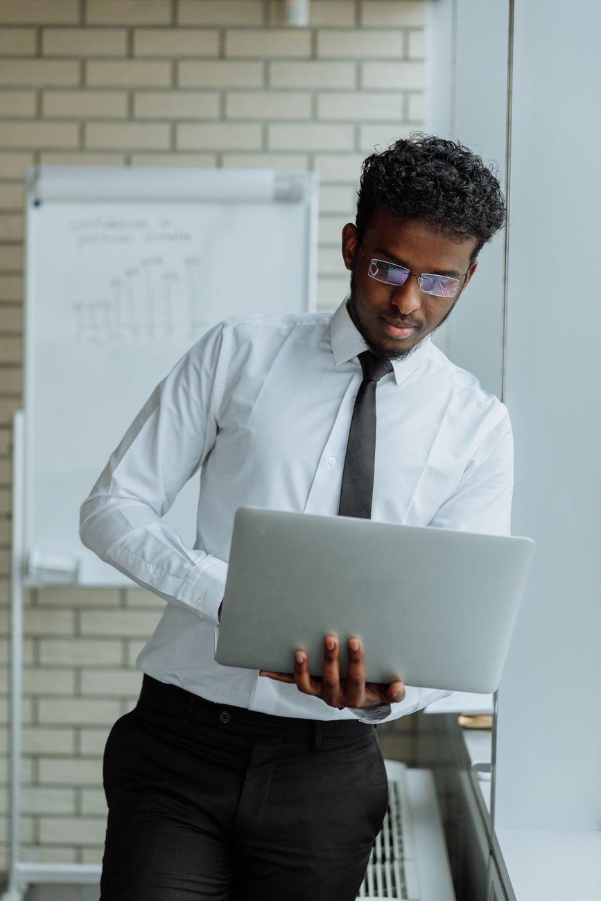 African entrepreneur working on laptop building digital creator business