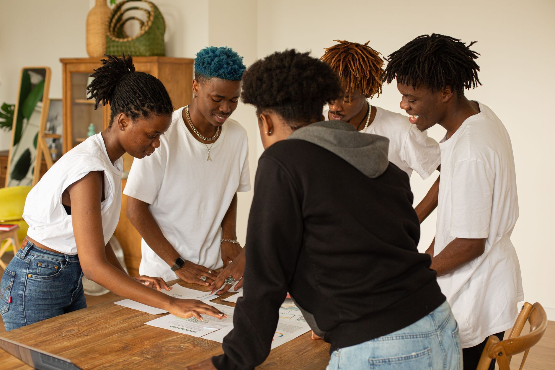 Group of young African creators collaborating on digital content strategy