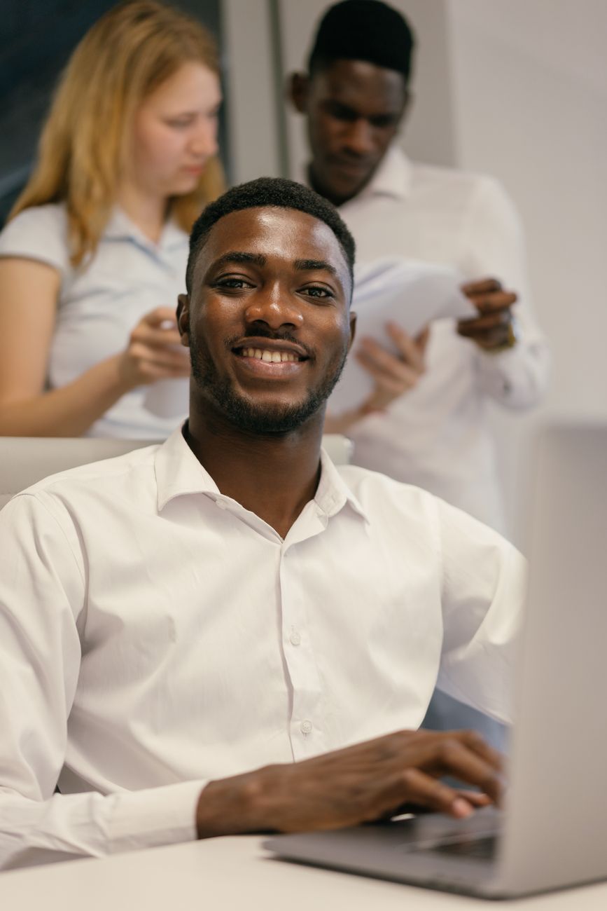 African entrepreneur working on laptop in a modern co-working space