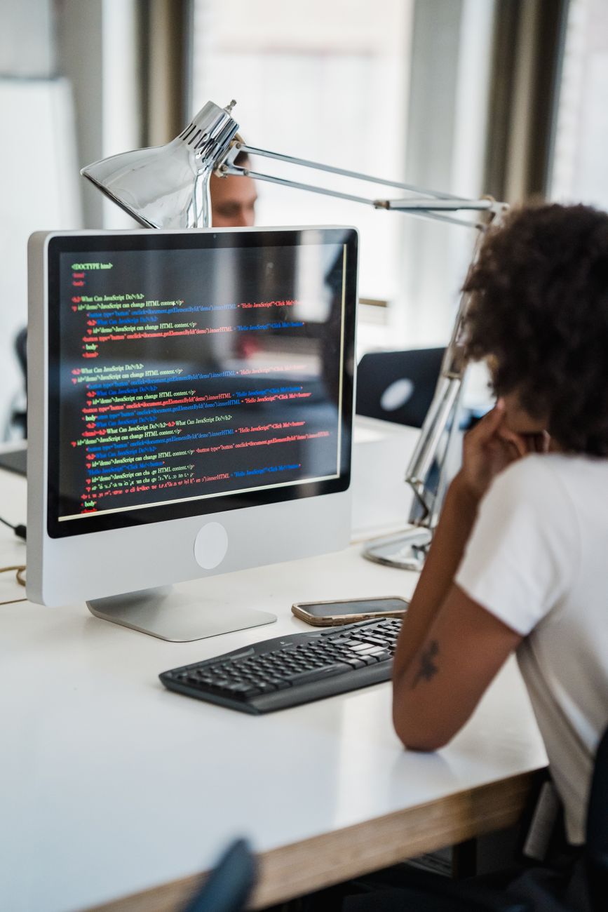 African software developer coding AI tools on a computer screen