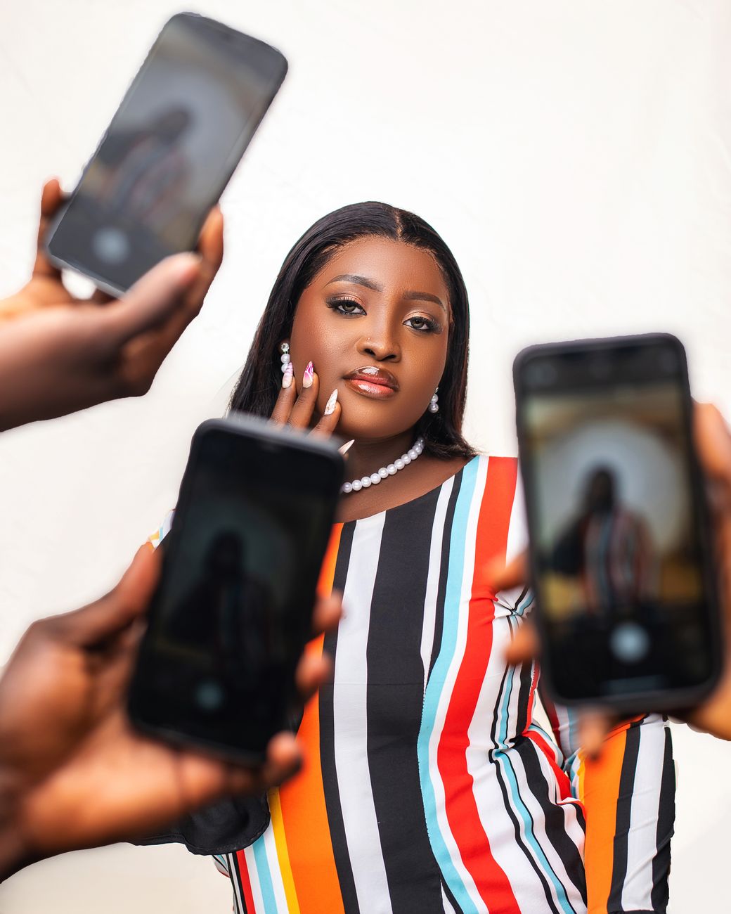 Smartphone showing African social media creator profiles with engagement metrics